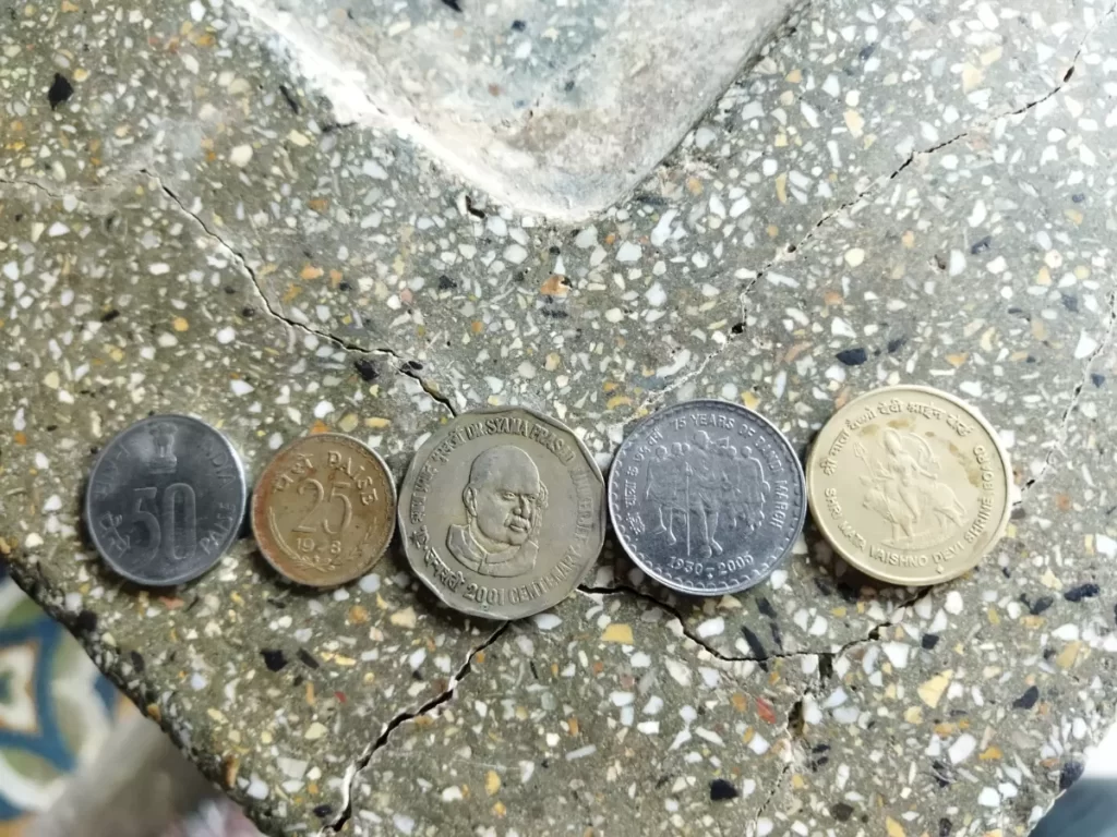 Indian coins on a stone surface